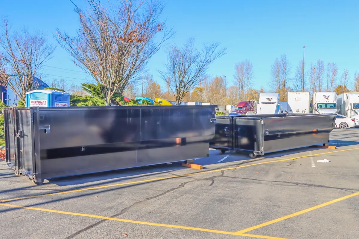 Professional dumpster rental service with roll-off container on residential driveway in Golden Hills